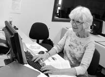 NICE COMPUTER: Marg McNeil tries to make friends with her computer at VIU.