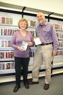 BUFFED MOVIES: Librarian Charlie Kregel and Friends of the Library volunteer Charlotte Shulz show off the new DVD collection at the Powell River Library.