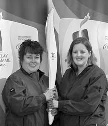 Bearing the torch: Joyce Carlson and Kim Barrows hold an Olympic torch aloft in anticipation of the February 3 event.